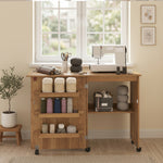 Mesa de costura plegable, mueble de costura abatible con cajones de almacenamiento, estante abierto y ruedas, marrón