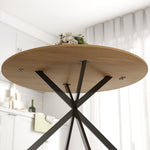 Table à manger ronde pour 4 personnes 120 cm style industriel avec plateau aspect bois, piètement croisé en acier, chêne