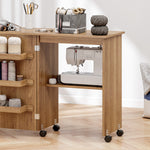 Mesa de costura plegable, mueble de costura abatible con cajones de almacenamiento, estante abierto y ruedas, marrón