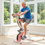 Vélo d'Appartement Pliable 4-en-1 - Ergomètre Magnétique Silencieux avec Cordes de Résistance - Sport Maison et Cardio-training avec Roulettes, Selle Confort et LCD (Max 120kg), Rose